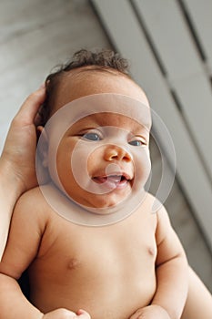 Smiling african baby, top view, mother pov