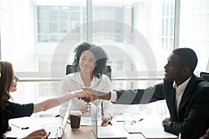 Smiling african businessman handshaking greeting caucasian busin