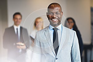 Smiling African businessman working in an office