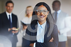 Smiling African businesswoman standing in an office