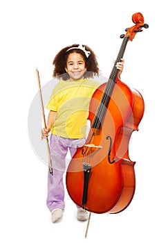 Smiling African girl holding cello and fiddlestick photo