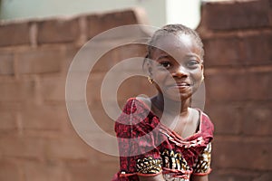 Smiling African Girl With a Wet Face After Having Taken A Sip From The Water Borehole