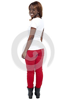 Smiling african lady in boots turning back