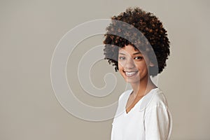Smiling African woman with an afro and natural complexion