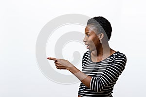 Smiling African woman pointing to the side