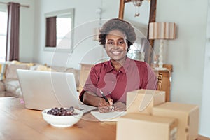 Smiling African woman working on her home based business