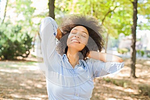 Smiling African Young Woman Dreaming With Closed Eyes In Nature