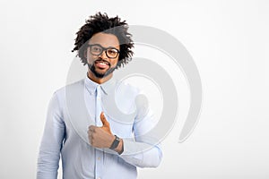 Smiling afro american man with curly hair showing thumbs up