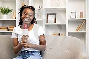 Smiling Afro American Woman Blogging with Microphone at Home