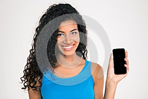 Smiling afro american woman showing blank smartphone screen