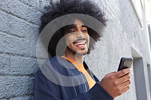 Smiling afro man using mobile phone
