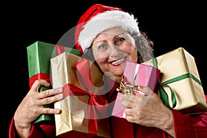 Smiling Aged Woman Embracing Four Wrapped Gifts