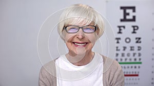 Smiling aged woman looking at camera, medical support for retired people