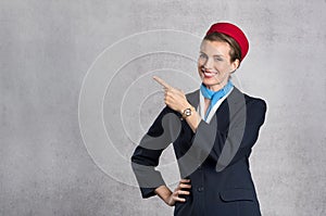 Smiling air hostess showing