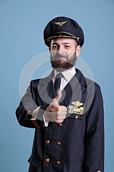 Smiling airplane aviator showing thumb up gesture