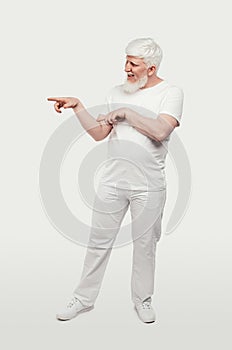 Smiling albino man pointing away