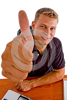 Smiling american male showing good luck sign