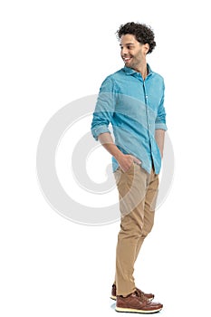 smiling arab man with curly hair looking behind and being happy