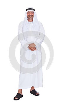Smiling arabian man standing over white background