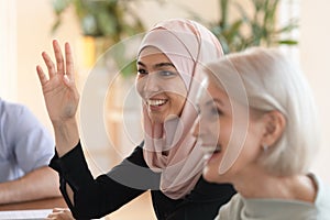 Smiling Arabic woman participate in team meeting in office photo