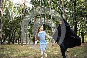 Smiling arbian mother and daughter holding