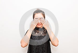 Smiling Asia woman covering eyes with her hands