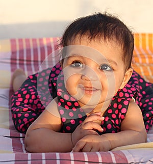 Smiling Asian baby girl looking at the viewer