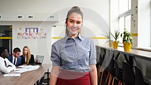 Smiling asian business woman in formal outfit looking at camera standing in an office. Portrait of happy pretty