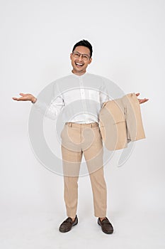 A smiling Asian businessman is opening his palms while standing on an isolated white background