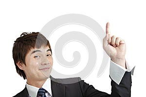 Smiling asian businessman pointing