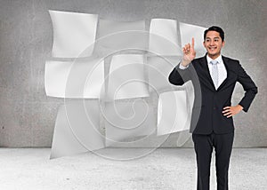 Smiling asian businessman pointing