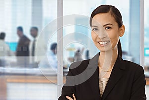 Smiling asian businesswoman in office