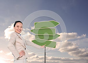 Smiling asian businesswoman pointing