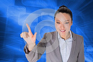 Smiling asian businesswoman pointing