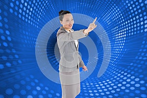 Smiling asian businesswoman pointing