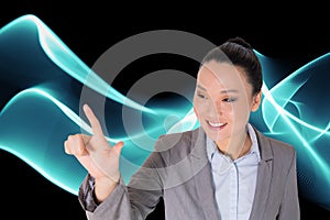 Smiling asian businesswoman pointing
