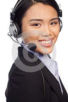 Smiling Asian call centre telephonist photo