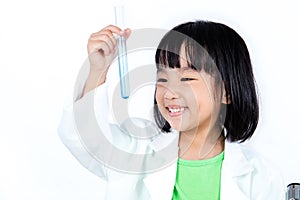 Smiling Asian Chinese Little Girl Examining Test Tube With Uniform