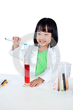 Smiling Asian Chinese Little Girl Examining Test Tube With Uniform