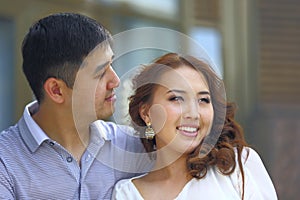 Smiling asian couple together looking to future