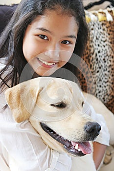 Smiling Asian girl with her pet dog