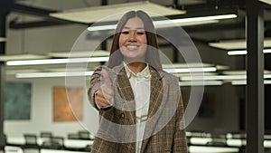 Smiling Asian girl student Korean happy business woman Japanese businesswoman female showing thumb up approve gesture