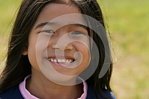 Smiling asian girl with toothy smile