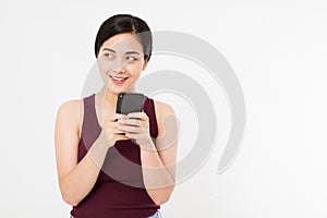 Smiling asian, japanese woman hold black smartphone, cellphone isolated on white background. Copy space.