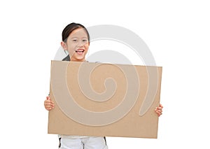 Smiling asian little girl holding empty brown big board for media banner isolated on white background with copy space