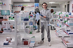 Smiling asian man buying pills bottle