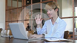 Smiling asian man making video conference, online distant job interview on laptop computer