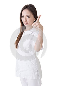 Smiling Asian nurse give an excellent sign