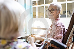 Smiling asian senior woman is happy to accidentally meet her close friend or good old friends in the hospital,elderly patients in