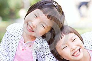 Smiling asian twin girls